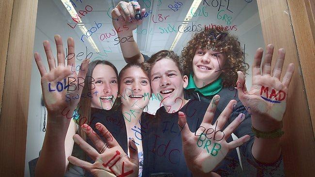 teens writing on mirror