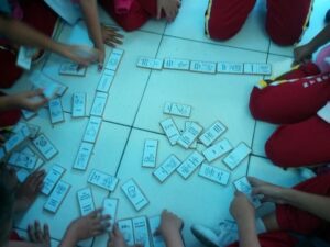 kids playing dominoes on the floor