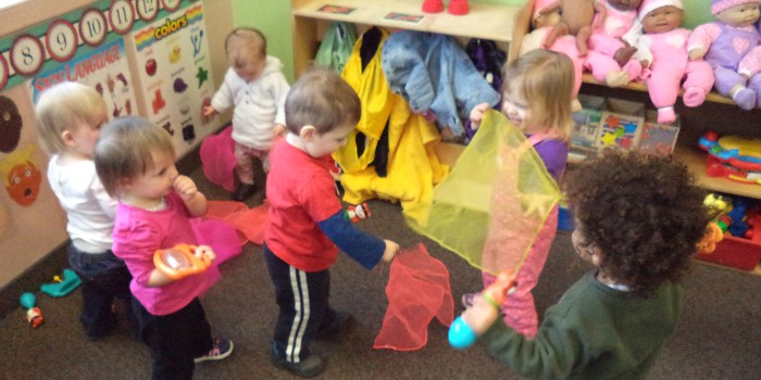 toddlers playing with scarves at kindergarten