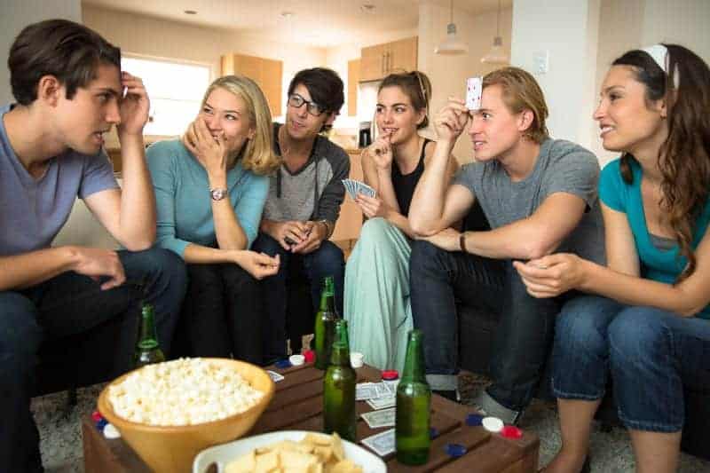 students playing a guessing card game