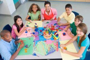 kids around a table doing a craft