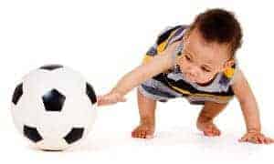 toddler playing with a football