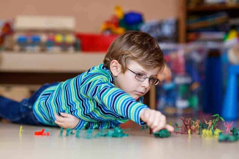 boy playing soldiers learning English through play