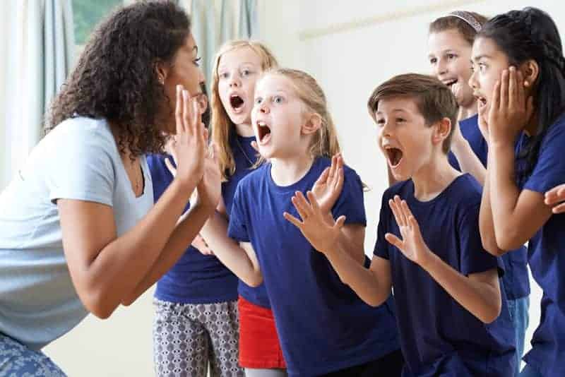 kids enjoying a drama activity in class