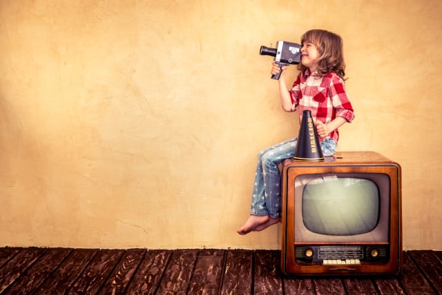 cute kid with vintage movie camera