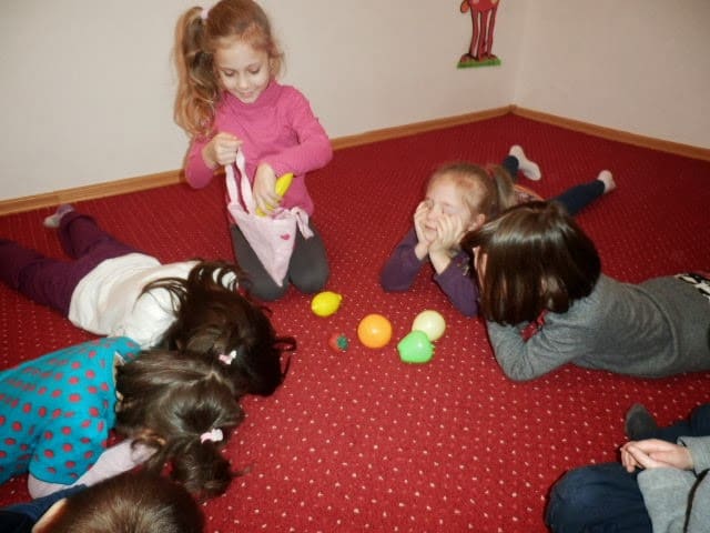 preschool kids playing a game with fruits