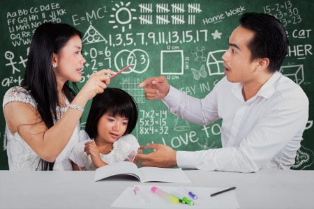 parents arguing while helping small child with school study